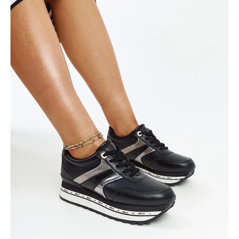 Black sneakers on the high sole of Mehari 1