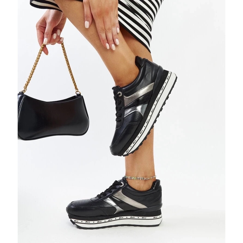 Black sneakers on the high sole of Mehari 2