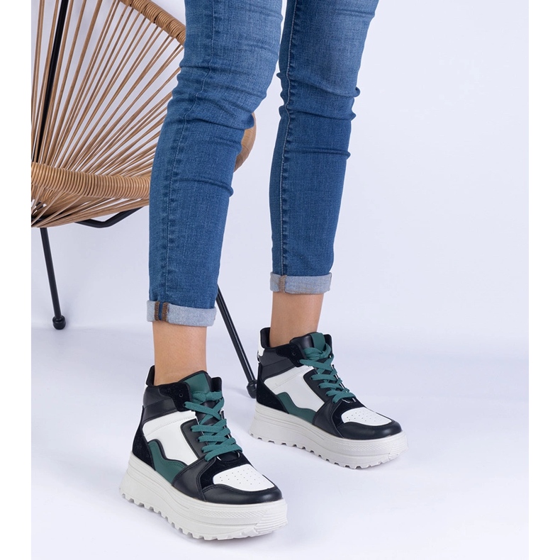 Black and white women's sports sneakers on the platform 1