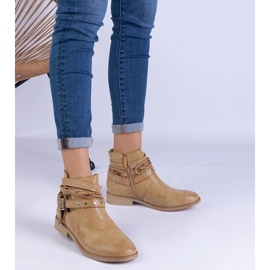 Brown flat boots with a cutout and a buckle 1
