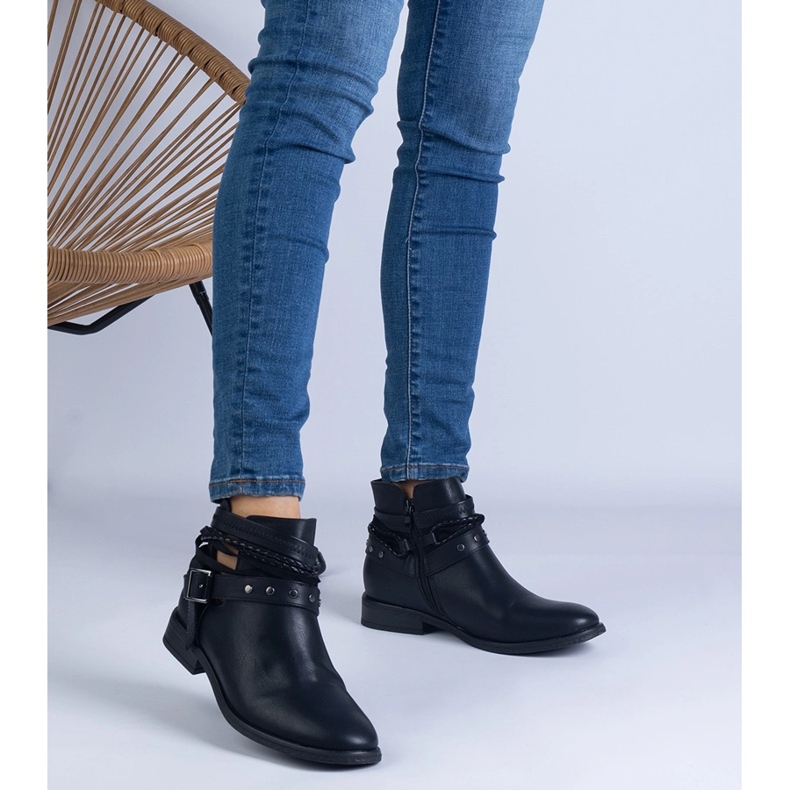 Black flat boots with a cutout and a buckle 1