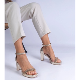 Golden elegant sandals on the pillar with zircons 1