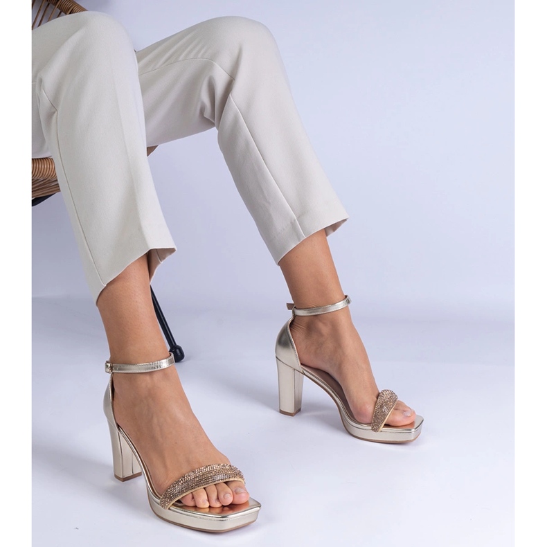 Golden elegant sandals on the pillar with zircons 1