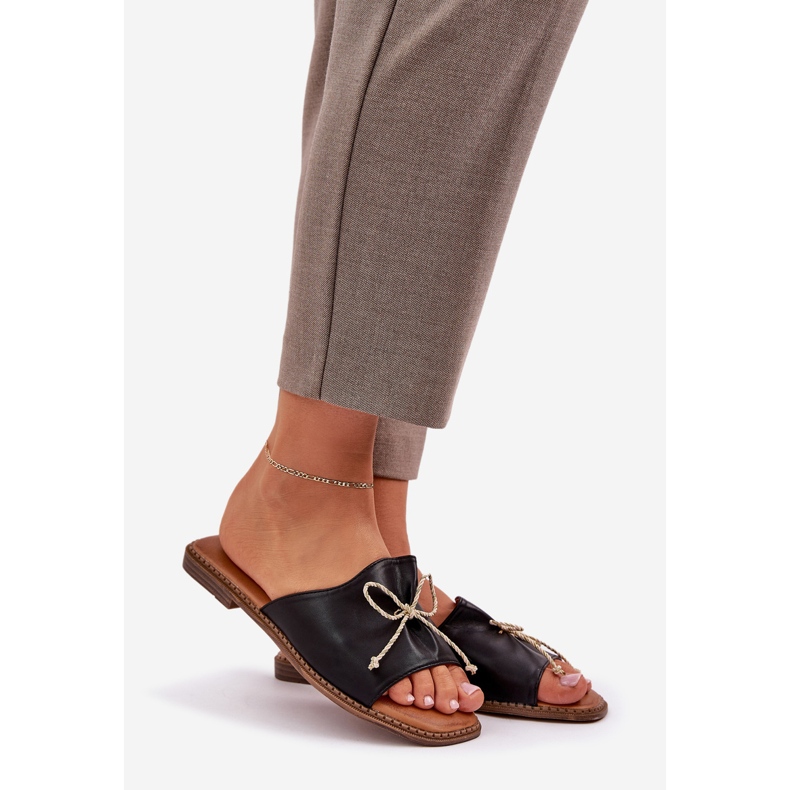 Flat sole flip flops with a decorative black bow 1