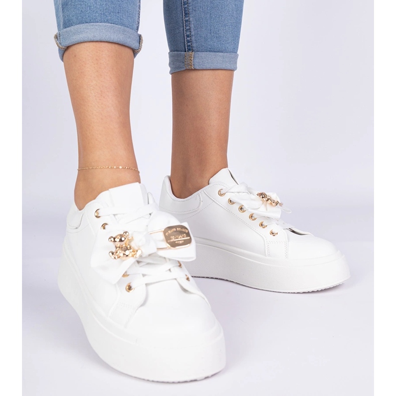 White sneakers decorated with a bow and a golden teddy bear 2
