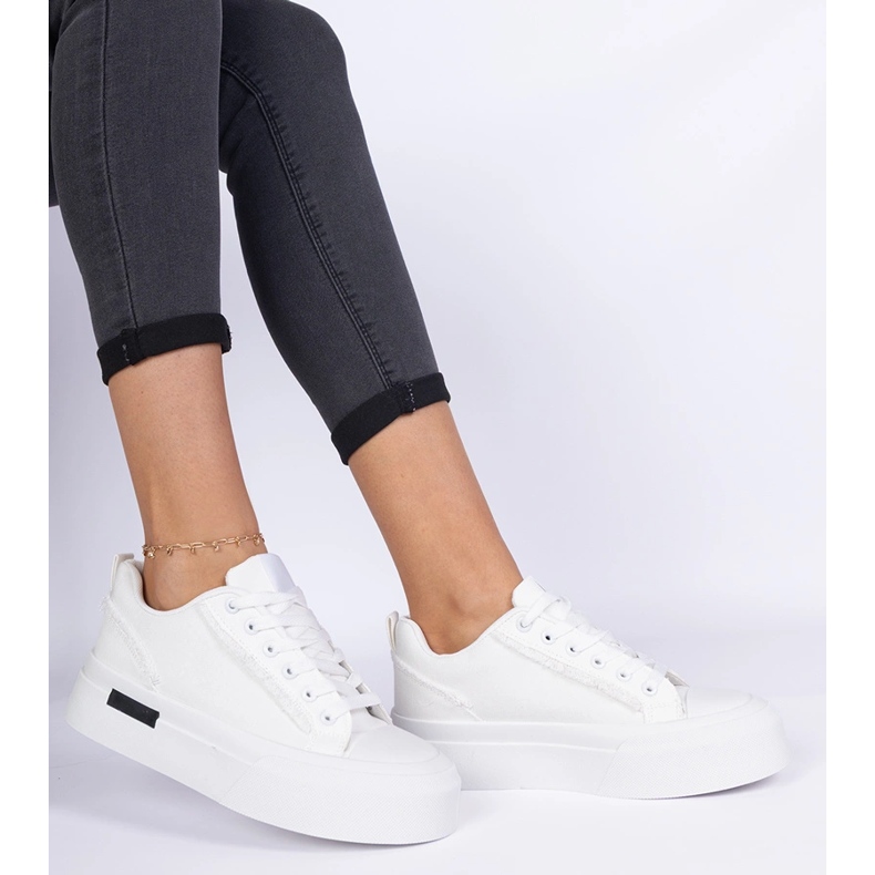 White women's material sneakers on the platform 2