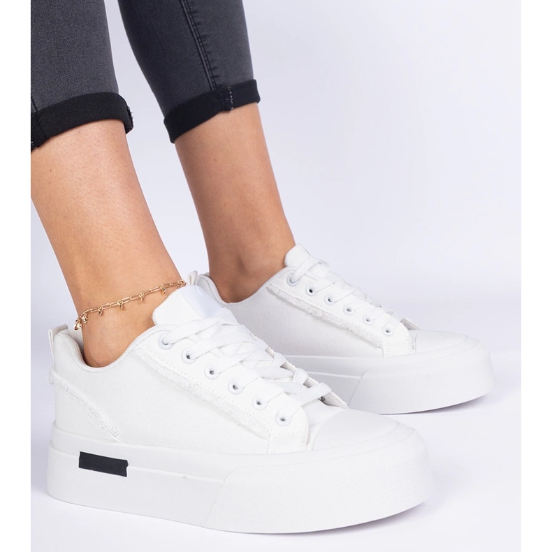 White women's material sneakers on the platform 1