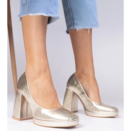 Golden metallic pumps on a massive post with a square toe 1