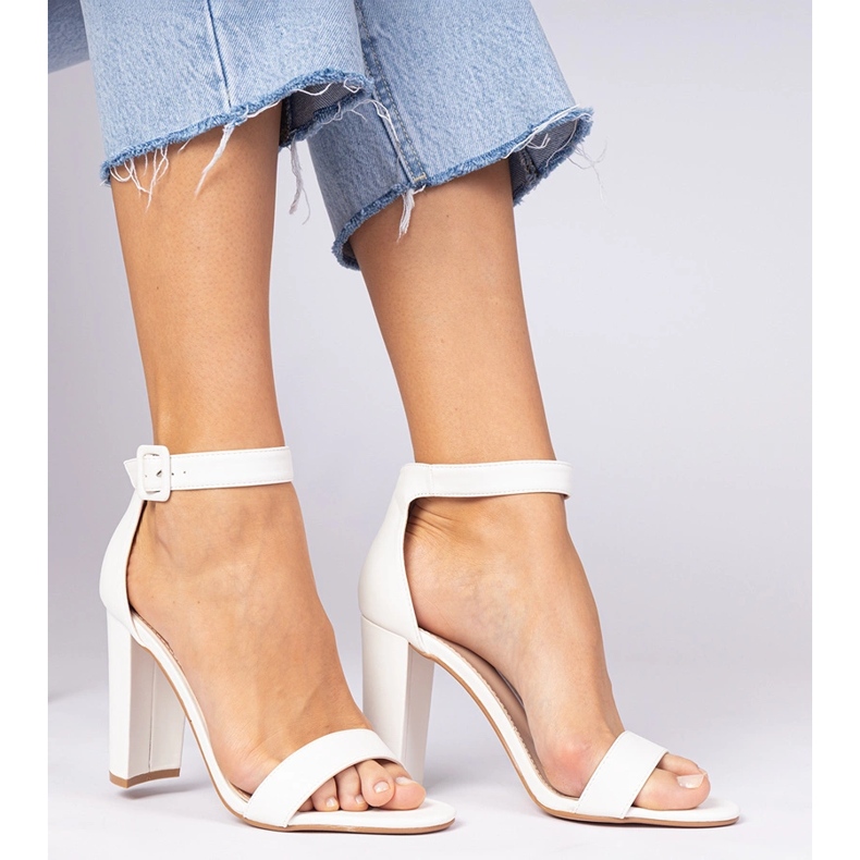 White sandals on the post fastened on the ankle 1