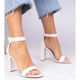 White sandals on the post fastened on the ankle 2