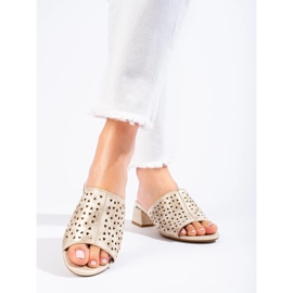 Openwork golden flip flops on a low metallic post 1