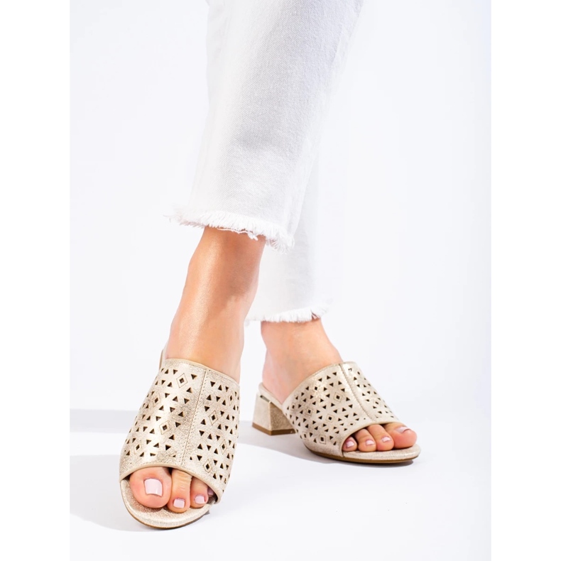 Openwork golden flip flops on a low metallic post 1