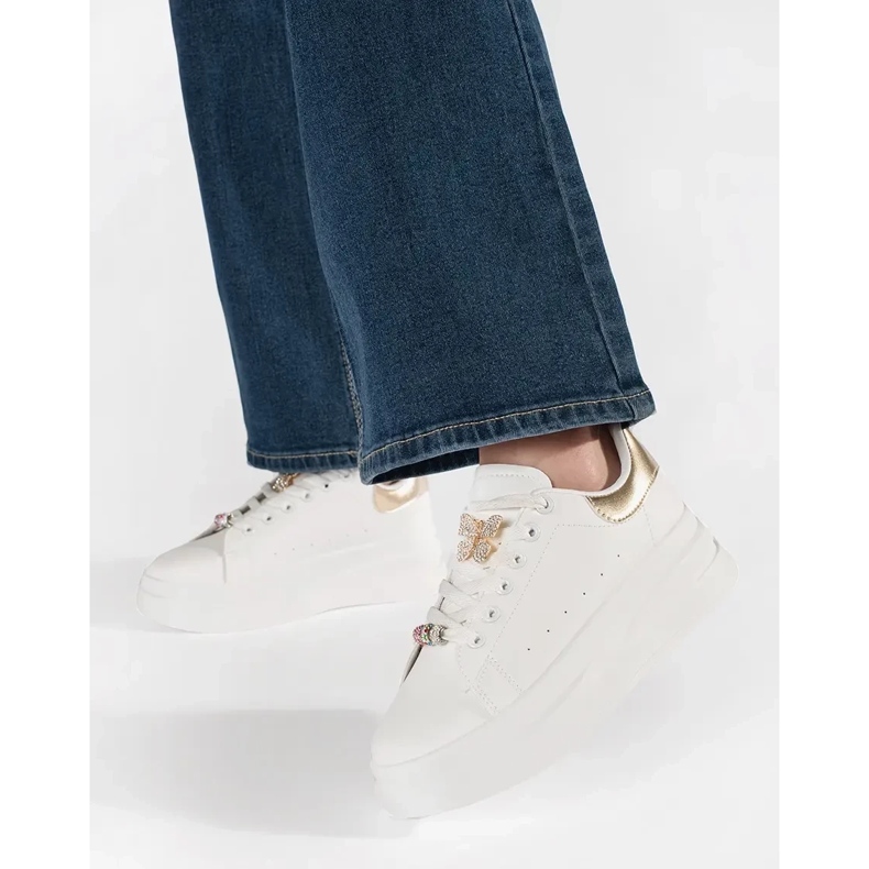 White sneakers on the platform with pin 1