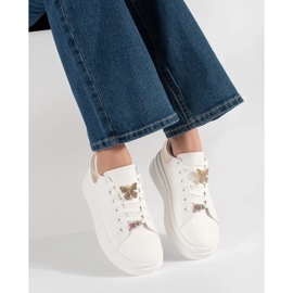 White sneakers on the platform with pin 2