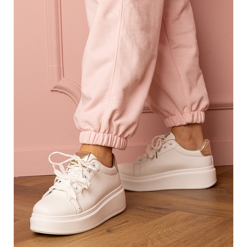 White and gold sports sneakers on the platform 1