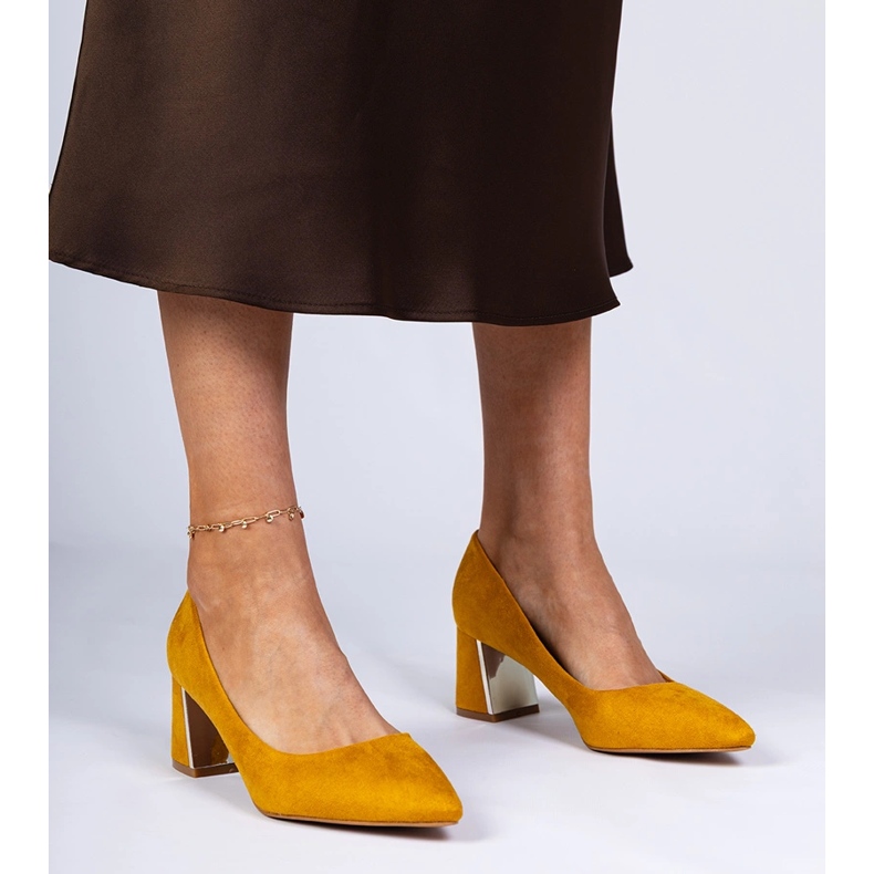 Yellow pumps on an elegantly decorated post 1