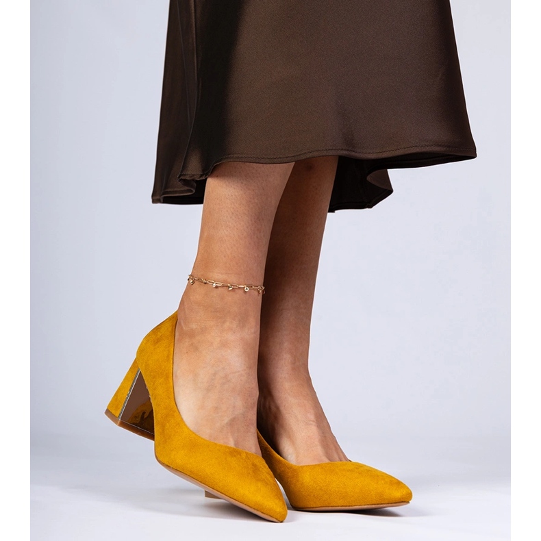 Yellow pumps on an elegantly decorated post 2