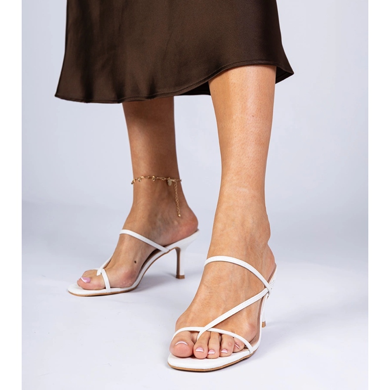 White elegant flip flops on a high heel 1