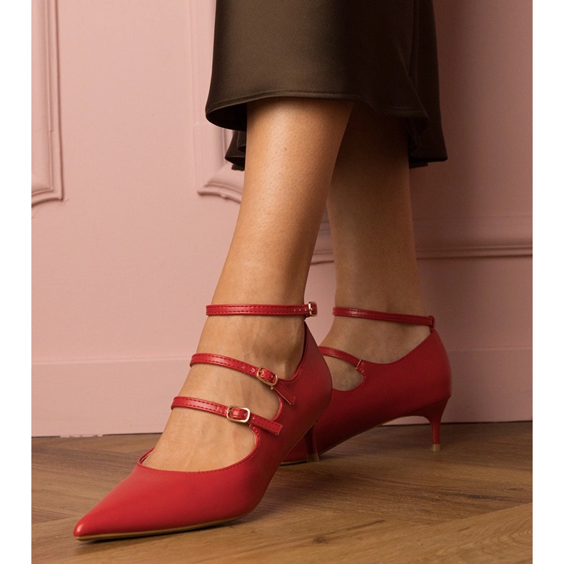 Red pumps on a low pile with buckles 1