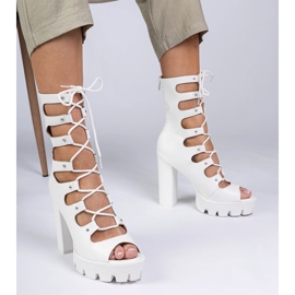 White boots on a high pillar with cutouts 1