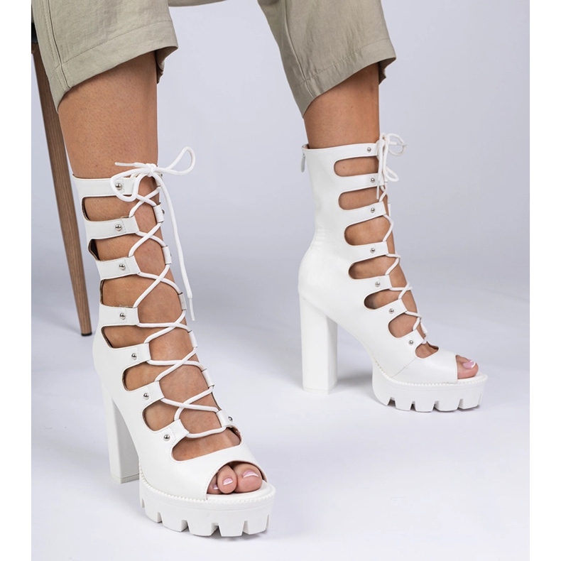 White boots on a high pillar with cutouts 1