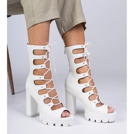 White boots on a high pillar with cutouts 2