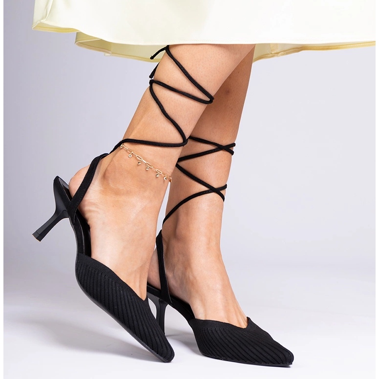 Black material pumps on a high heel with open 2
