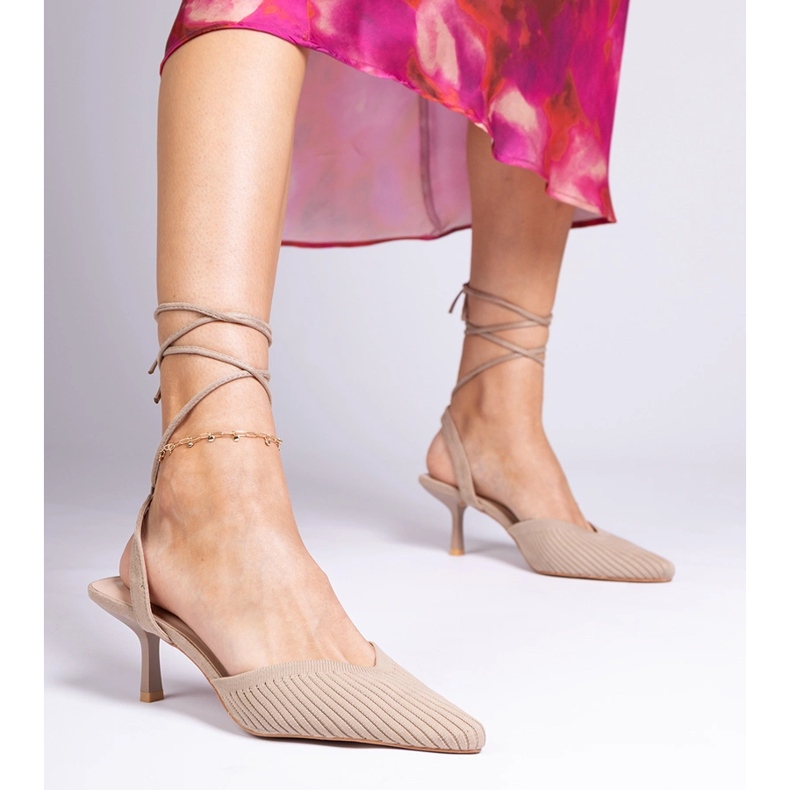 Brown material pumps on a high heel with open 1