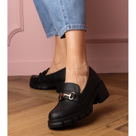 Black shoes on a low post with a golden decoration 1