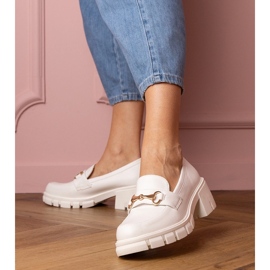 White shoes on a low post with a golden ornament 1 White shoes on a low post with a golden ornament 1