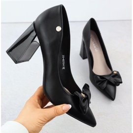 Women's pumps on a decorative post with a black Vinceza 62104 bow 1