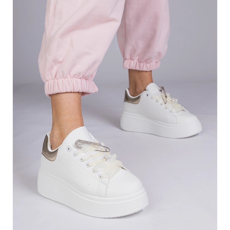 White sneakers with a golden insert and a zircon pin 1