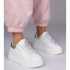 White sneakers with a silver insert and a pin with zircons 1