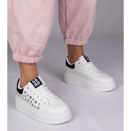 White sneakers with a black insert and studs 1