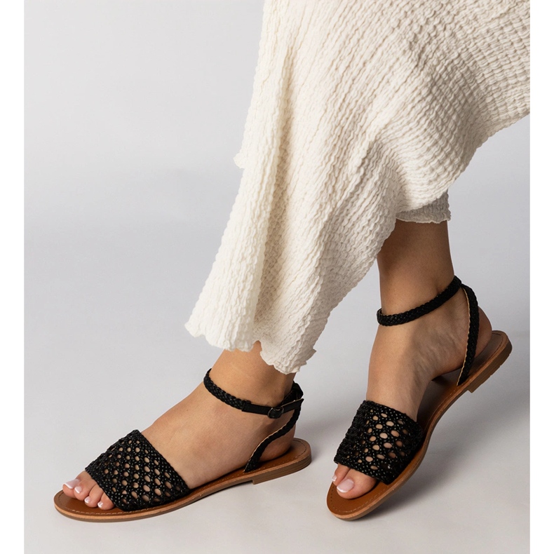 Black sandals woven on a flat sole 1