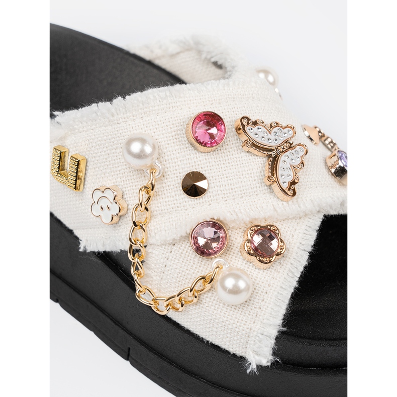 Seastar White flip flops on a black platform with pins 1