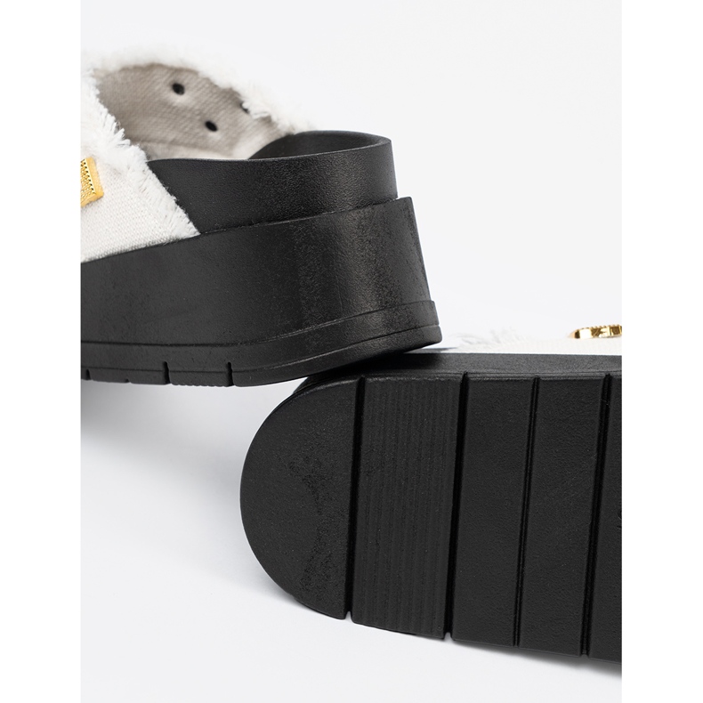 Seastar White flip flops on a black platform with pins 2