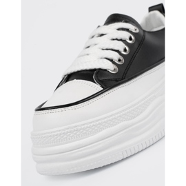 Black and white sneakers on the platform 1