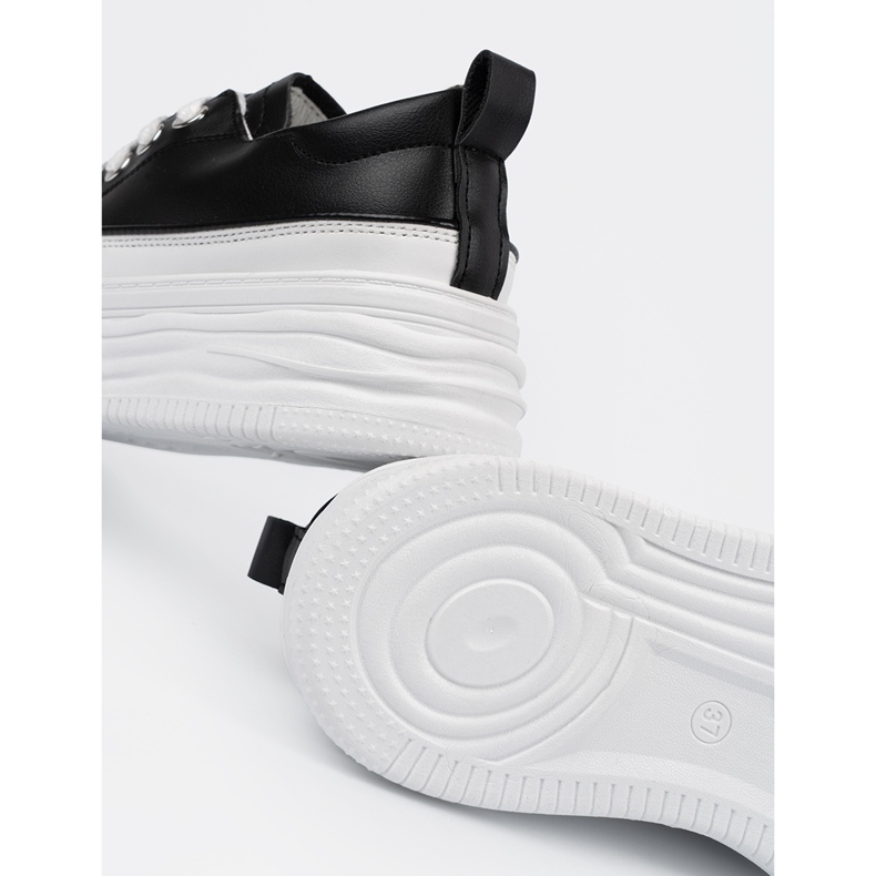 Black and white sneakers on the platform 2