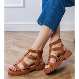 Brown gladiator sandals fastened with a cube 2