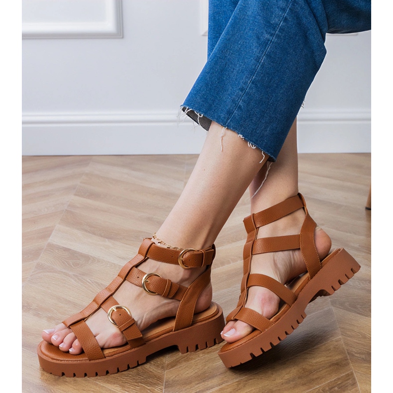 Brown gladiator sandals fastened with a cube 2