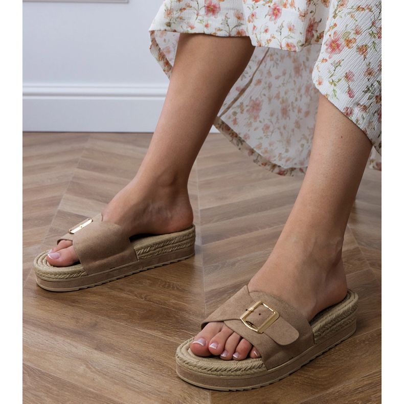 Brown flip flops on the platform with a buckle on the belt 1