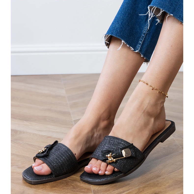 Black flat flip flops with a golden decoration 2