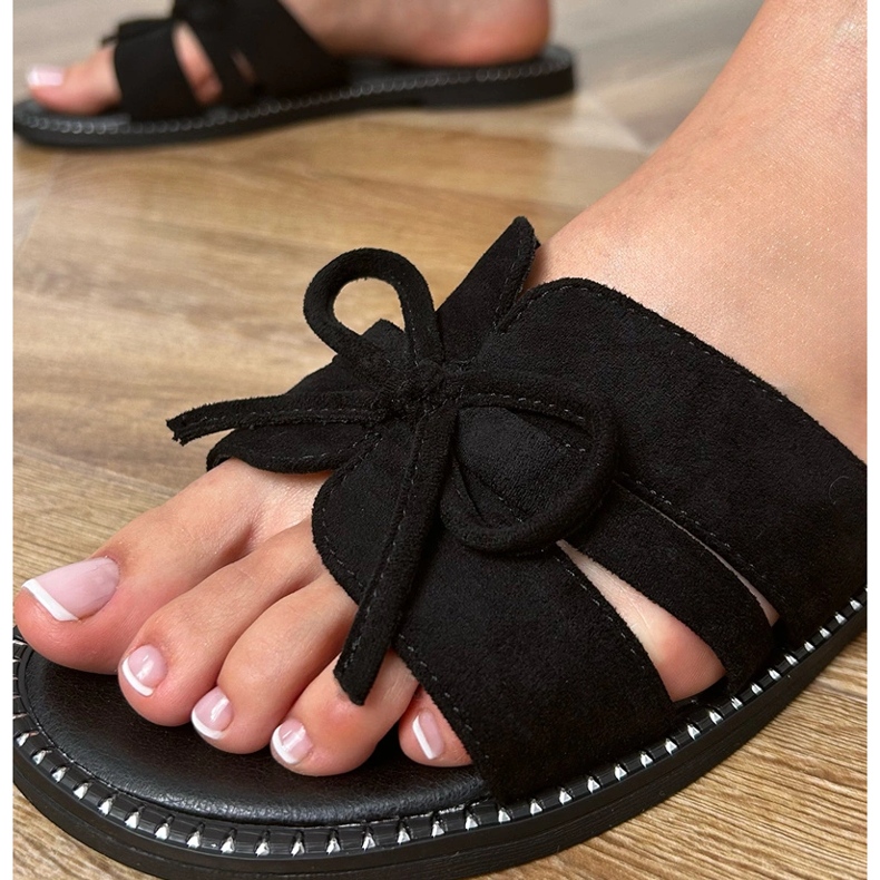 Black flip flops with a bow and decoration at the edges 1
