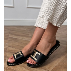 Black flip flops with a golden decoration on the belt 1