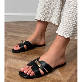 Black flip flops with cutouts on the belt and golden decoration. 1