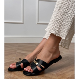 Black flip flops with cutouts on the belt and golden decoration. 2
