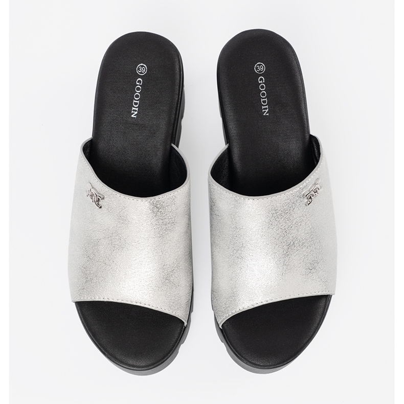 Goodin Silver flip flops on a black platform 2
