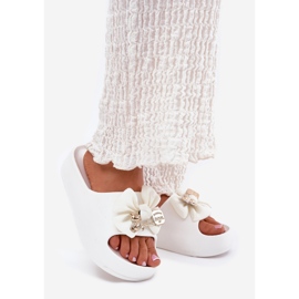 Women's foam slippers on the platform with a bow and a white brooch 1