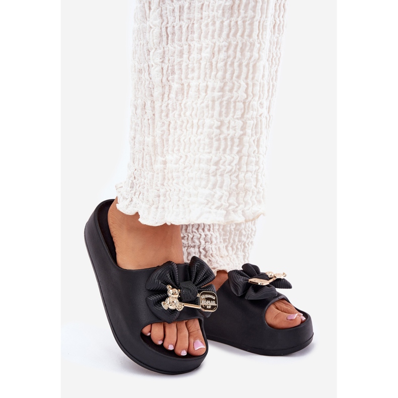 Women's foam slippers on the platform with a bow and a black brooch 1